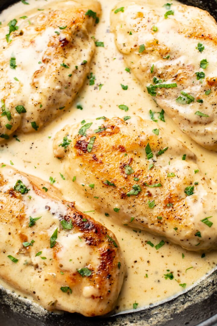 closeup of a skillet with creamy white wine chicken