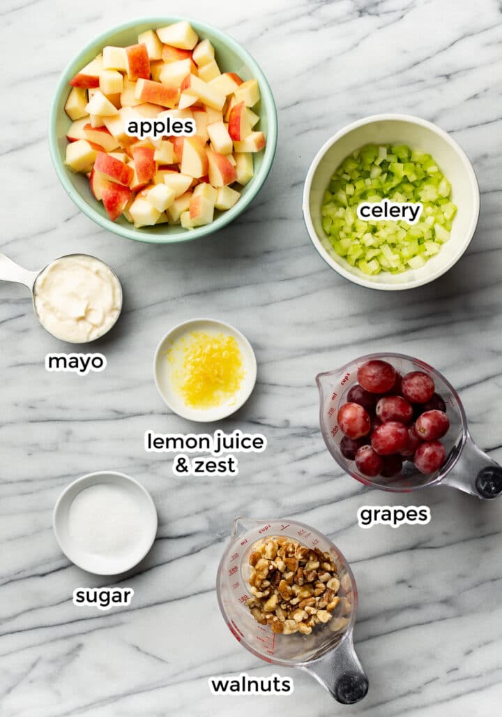 ingredients for waldorf salad on a marble counter