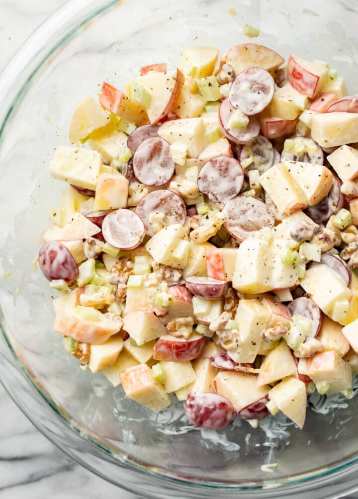 a glass bowl with waldorf salad