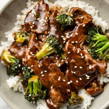 a bowl of beef and broccoli over rice