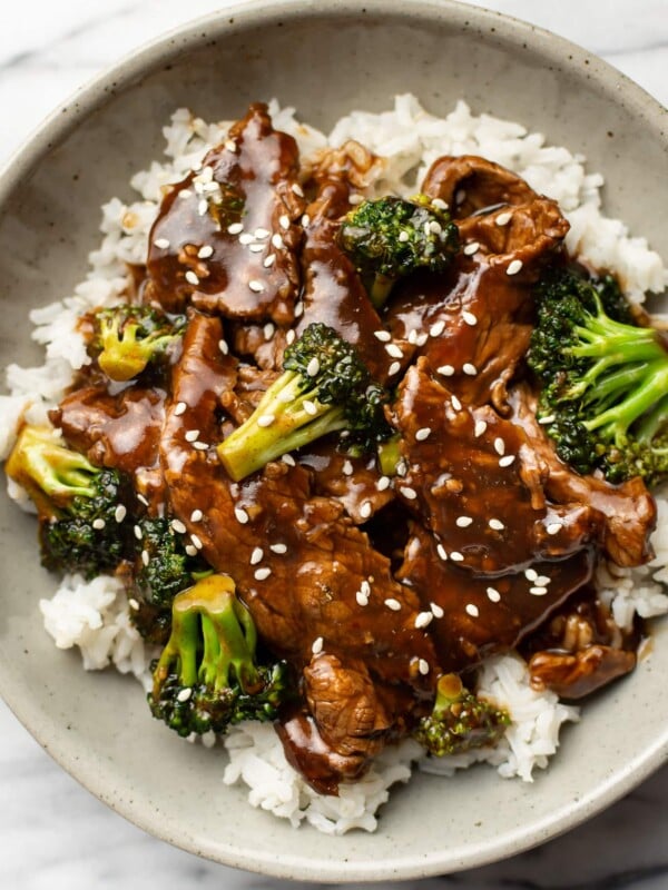 a bowl of beef and broccoli over rice