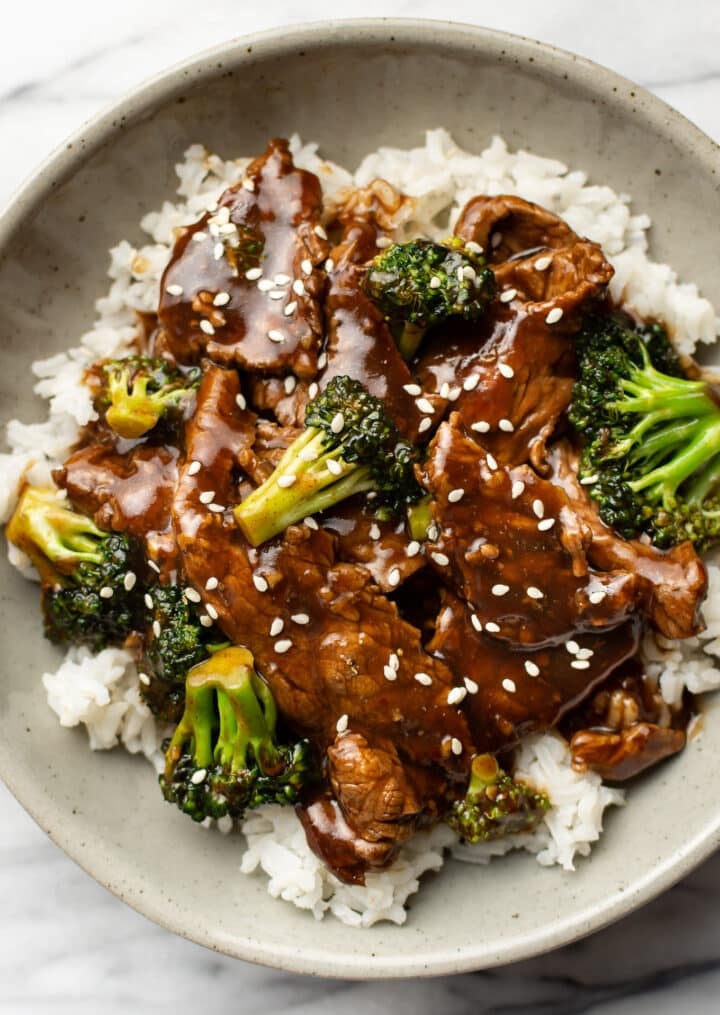 a bowl of beef and broccoli over rice