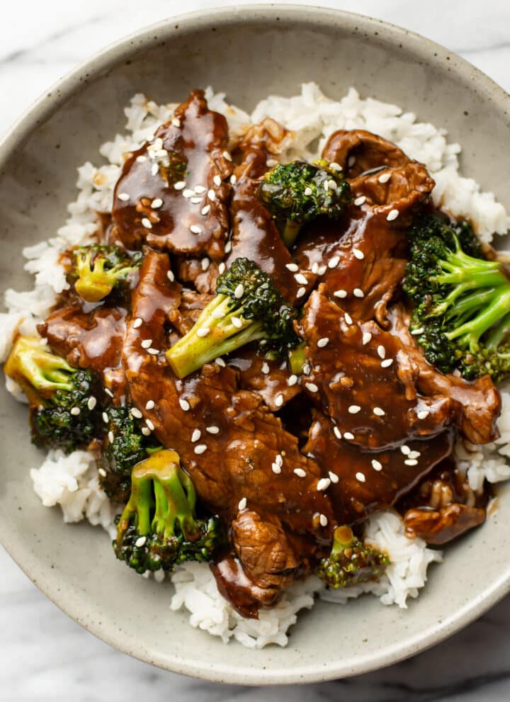 a bowl of beef and broccoli over rice