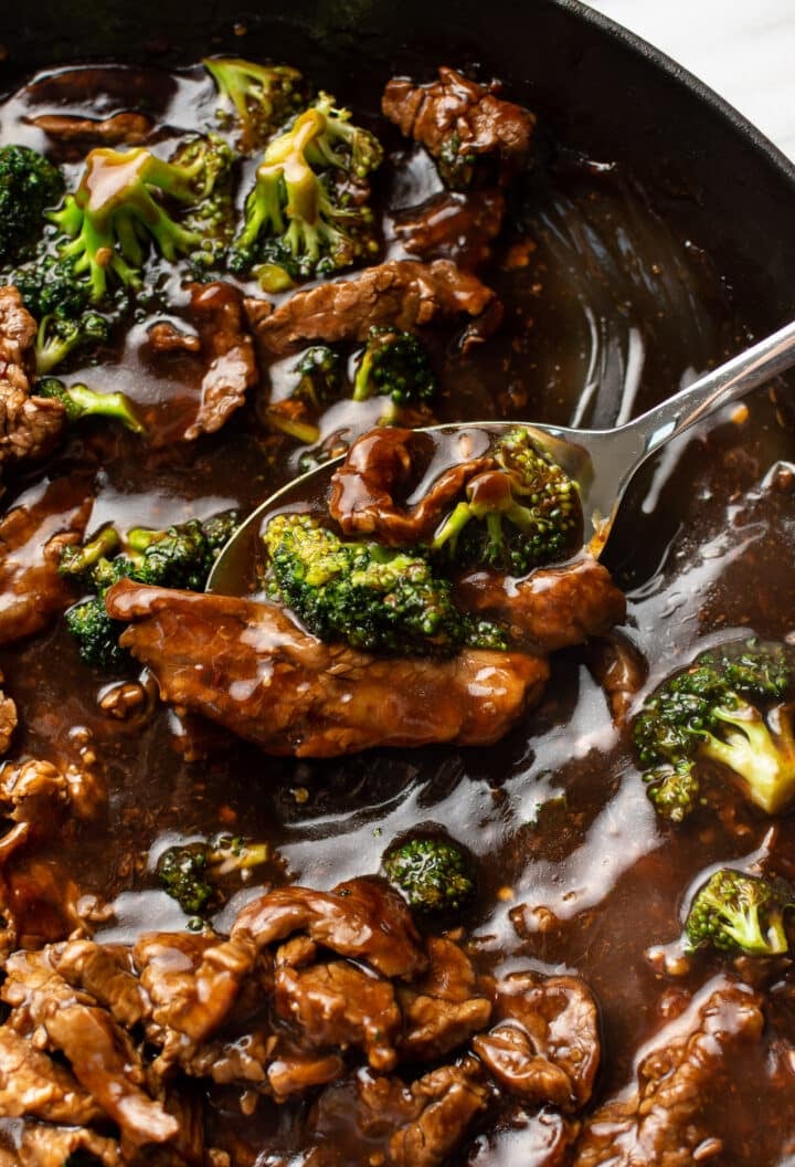 closeup of a serving spoon with beef and broccoli