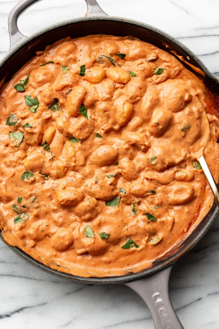 a cast iron skillet with tomato goat cheese gnocchi