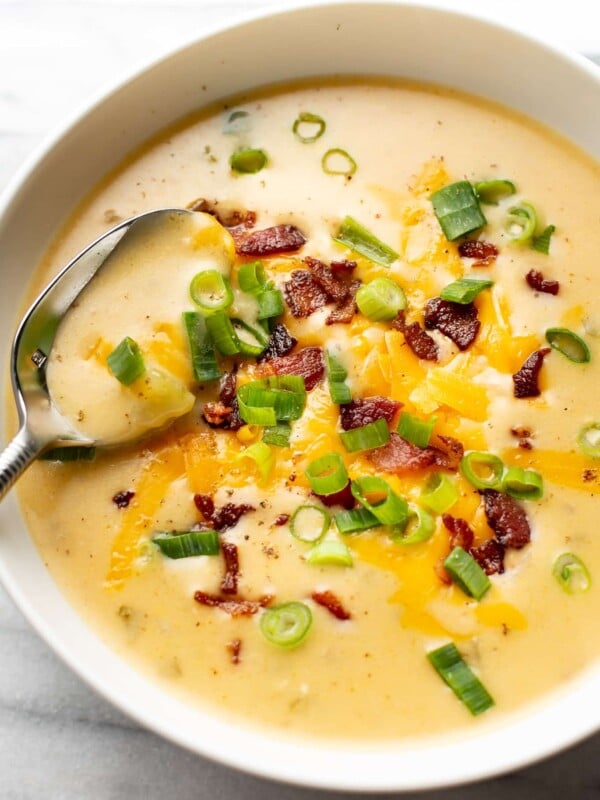 a bowl of beer cheese soup with a spoon