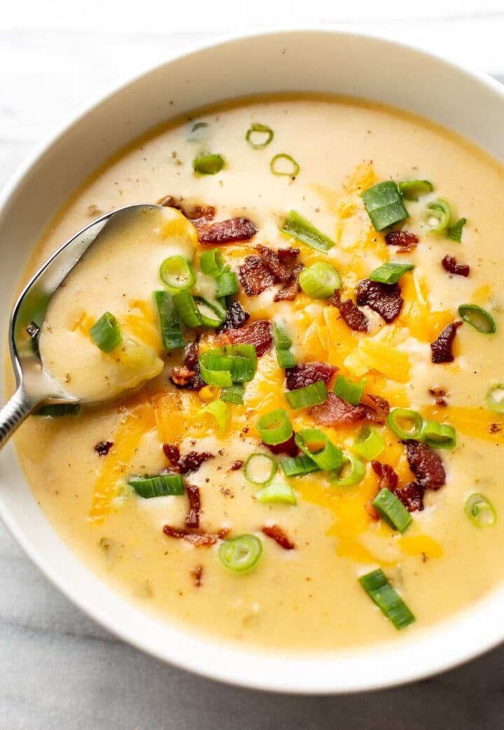 a bowl of beer cheese soup with a spoon