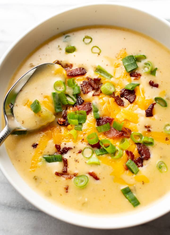 a bowl of beer cheese soup with a spoon