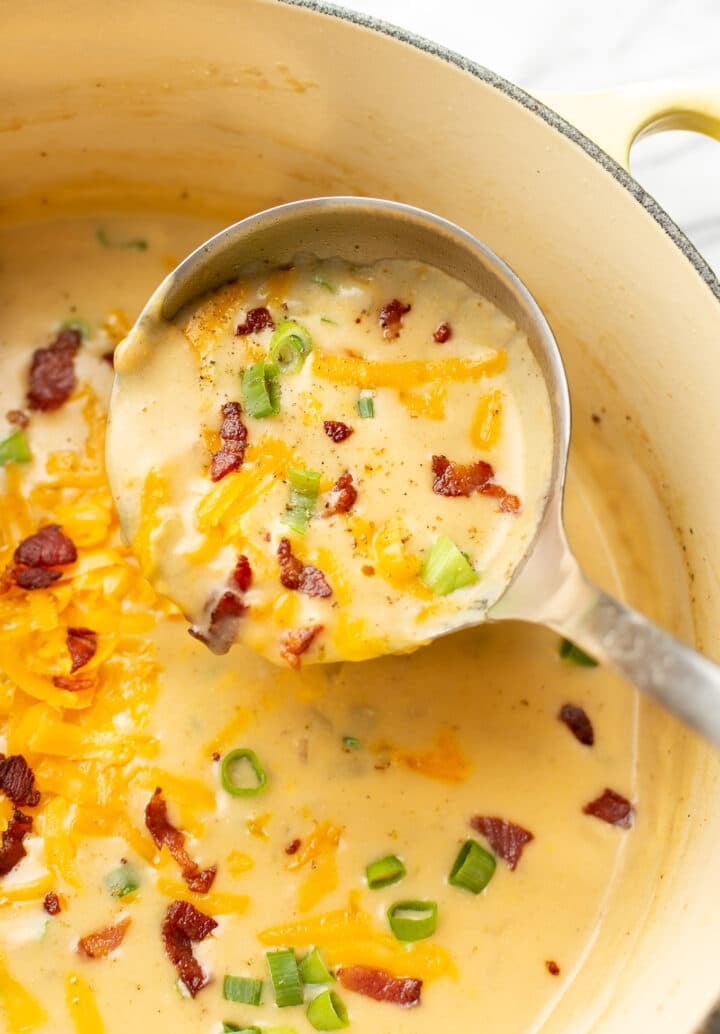 a ladle with beer cheese soup