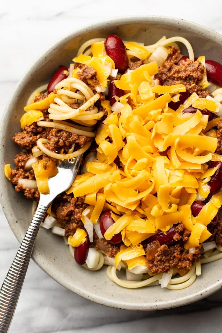 a bowl of cincinnati chili with a fork