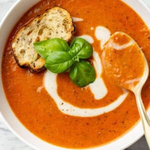 a bowl of tomato soup with a spoon