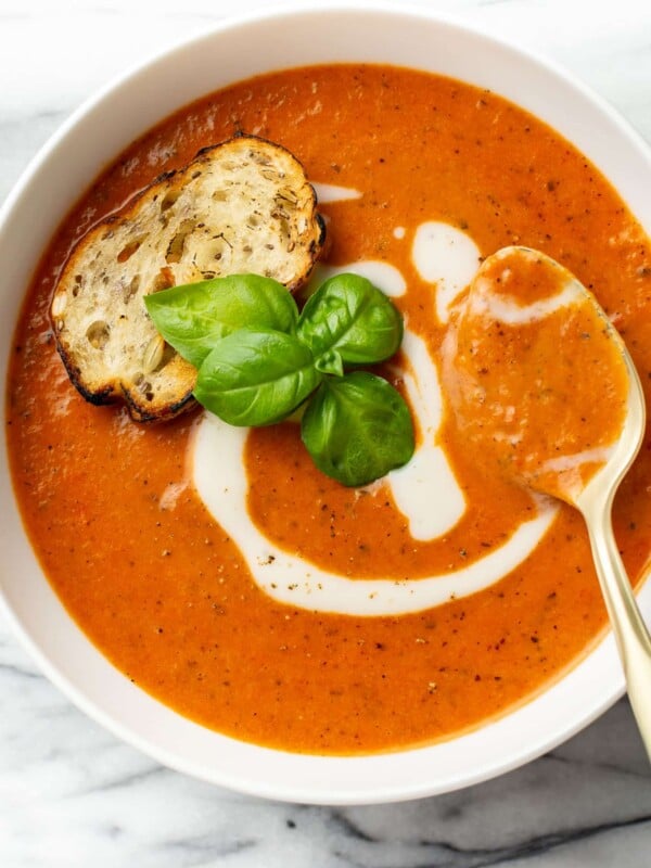 a bowl of tomato soup with a spoon