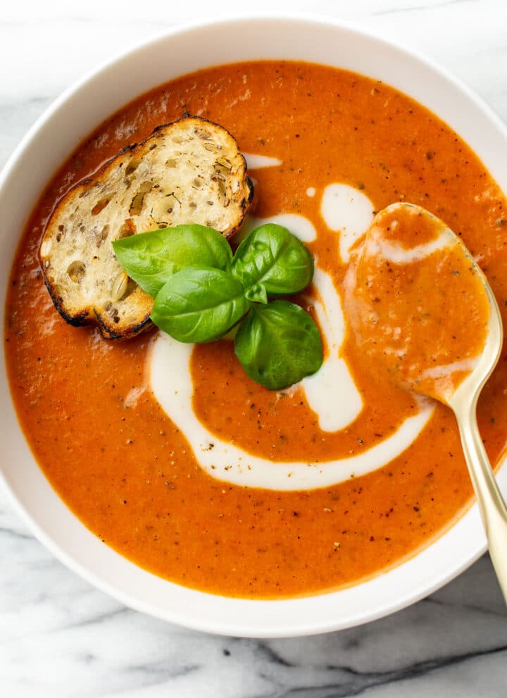 a bowl of tomato soup with a spoon