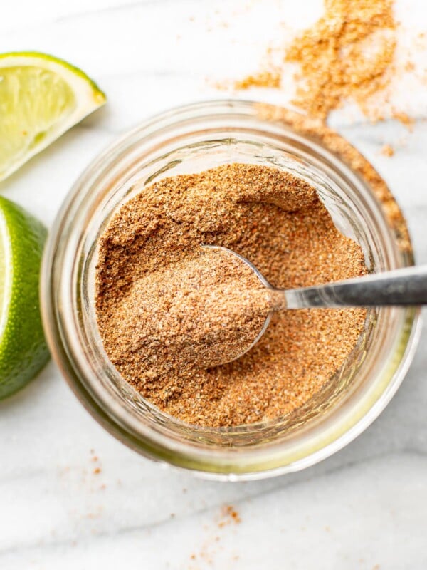 a jar with taco seasoning and a spoon