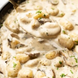 closeup of a skillet with a spoonful of creamy boursin gnocchi