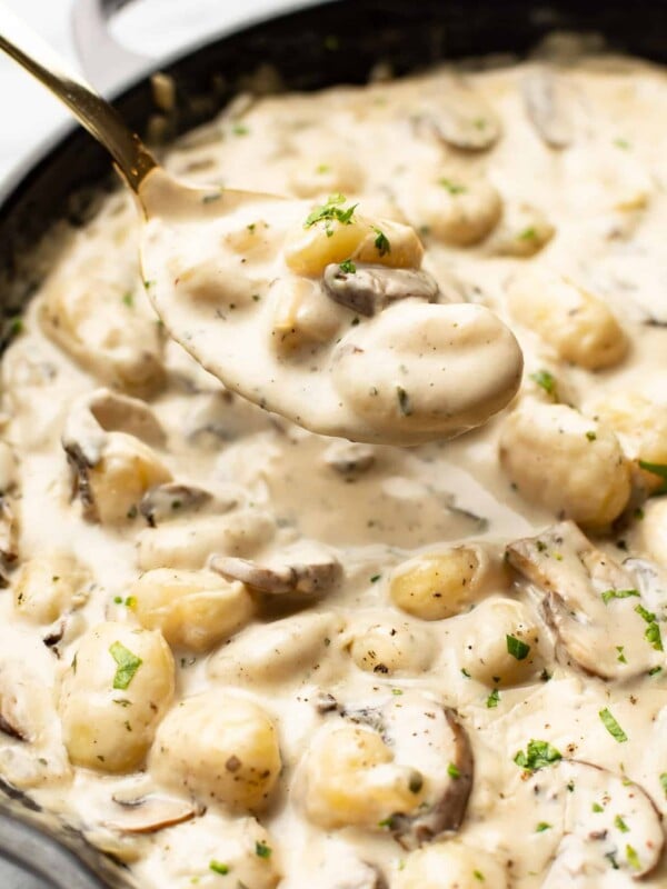 closeup of a skillet with a spoonful of creamy boursin gnocchi