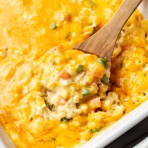 a serving spoon with chicken and rice casserole