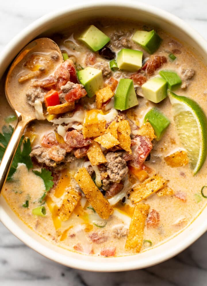 a bowl of creamy taco soup with a spoon