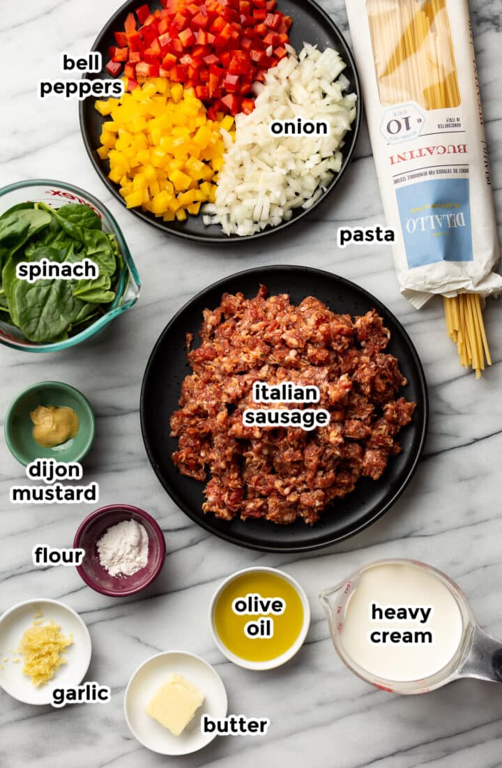 ingredients for sausage and peppers pasta in prep bowls