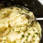 closeup of boursin mashed potatoes with a whisk