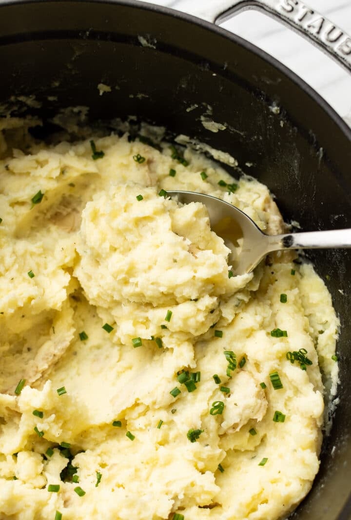 closeup of boursin mashed potatoes with a whisk