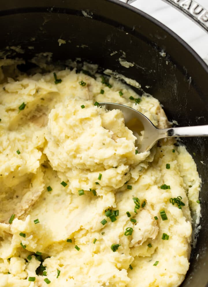 closeup of boursin mashed potatoes with a whisk