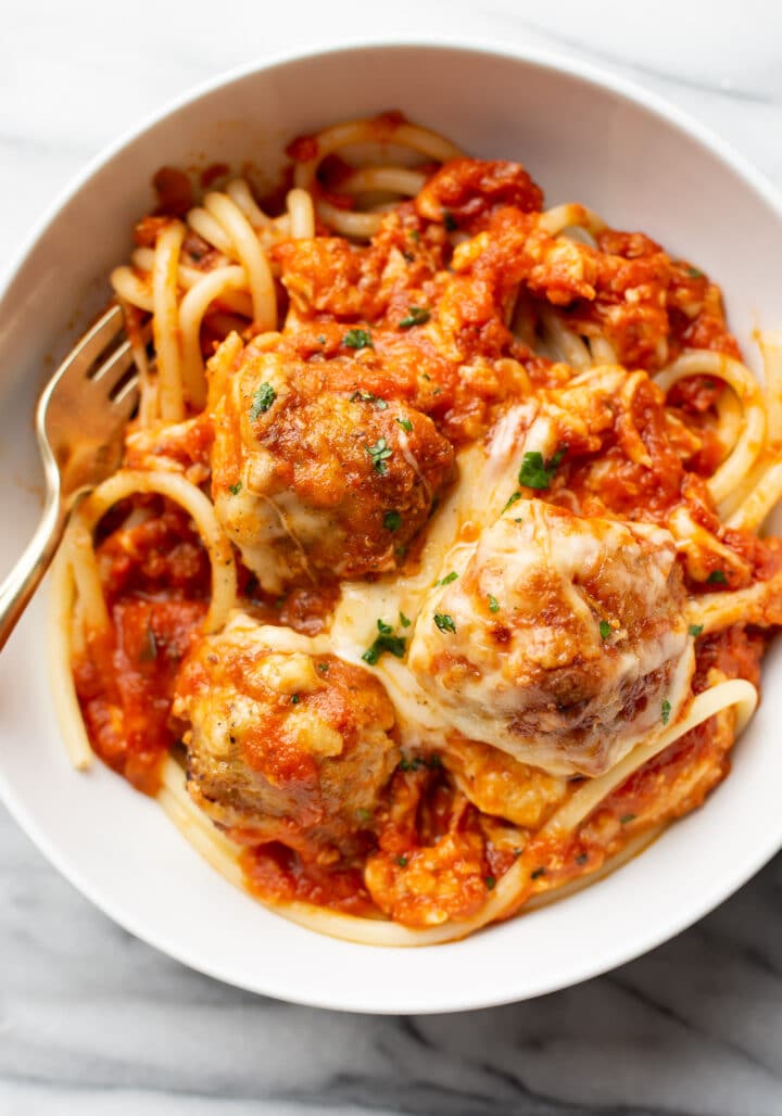 a bowl of spaghetti with chicken parmesan meatballs