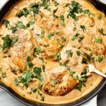 a skillet with creamy southwest chicken and a serving spoon