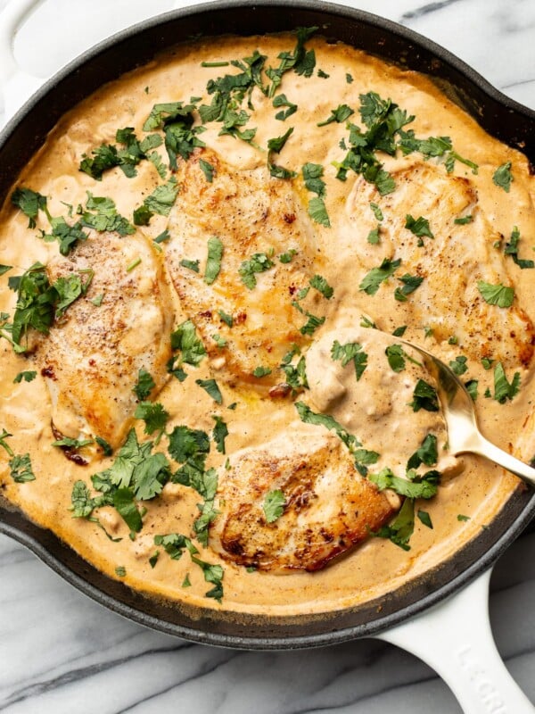 a skillet with creamy southwest chicken and a serving spoon