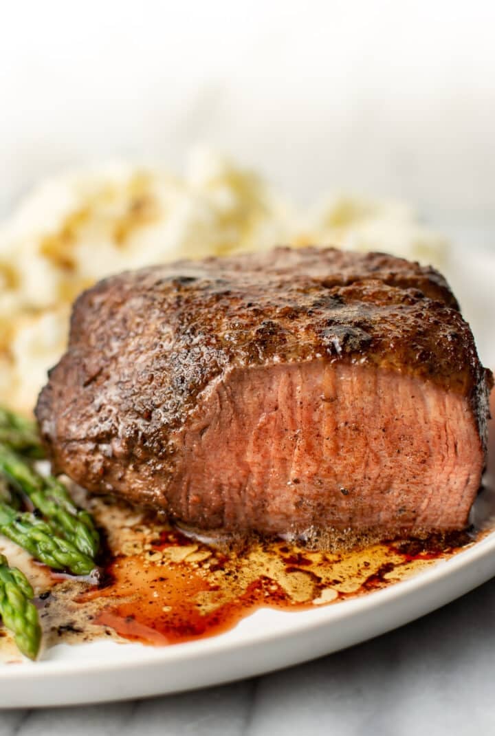 filet mignon on a plate with mashed potatoes