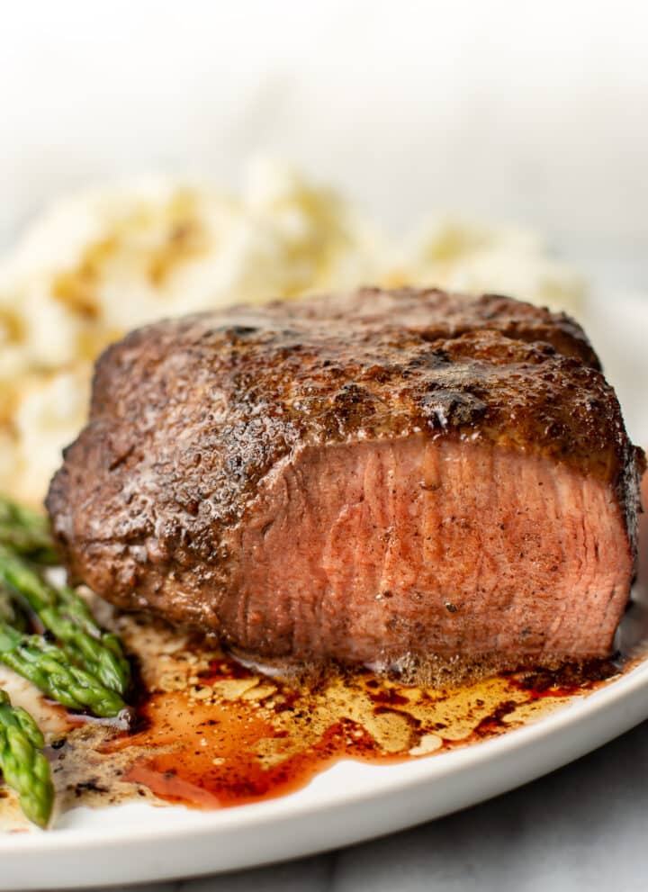 filet mignon on a plate with mashed potatoes