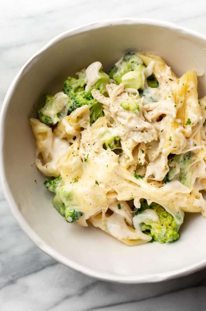 a bowl of chicken and broccoli alfredo bake