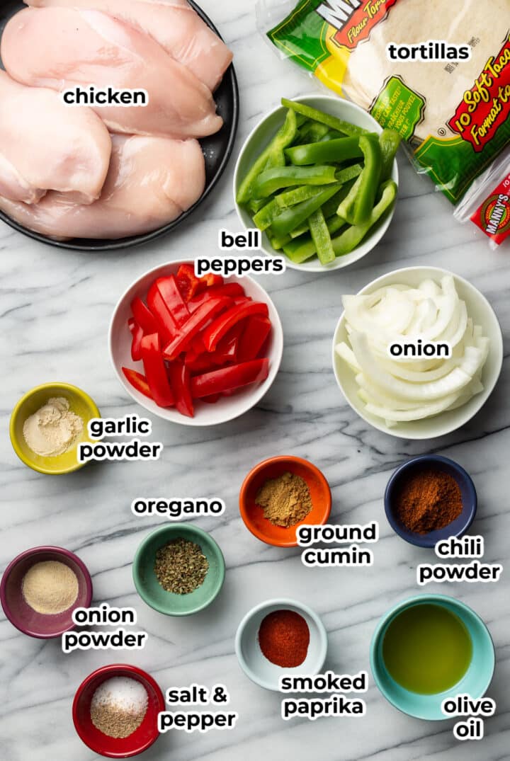 ingredients in prep bowls for sheet pan chicken fajitas