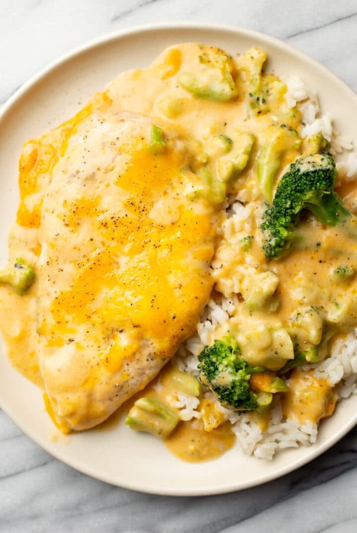 a plate with cheesy chicken, broccoli, and rice