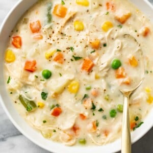 a bowl of chicken pot pie soup with a spoon