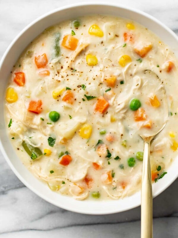 a bowl of chicken pot pie soup with a spoon