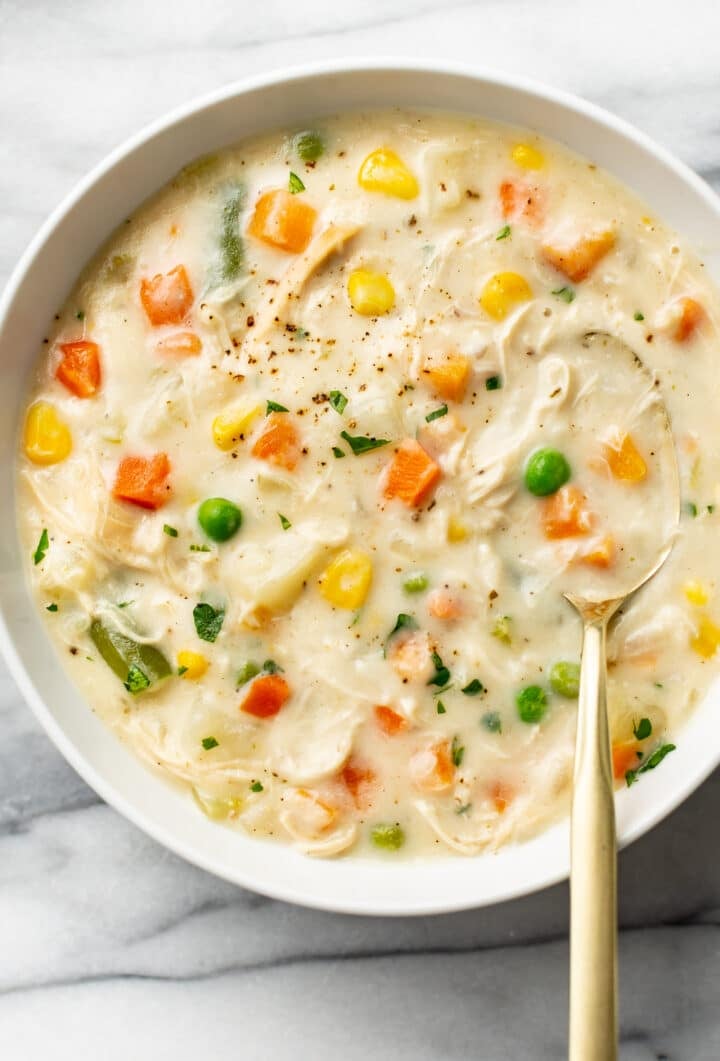 a bowl of chicken pot pie soup with a spoon