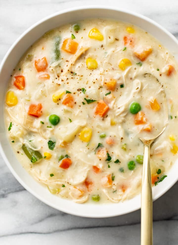 a bowl of chicken pot pie soup with a spoon