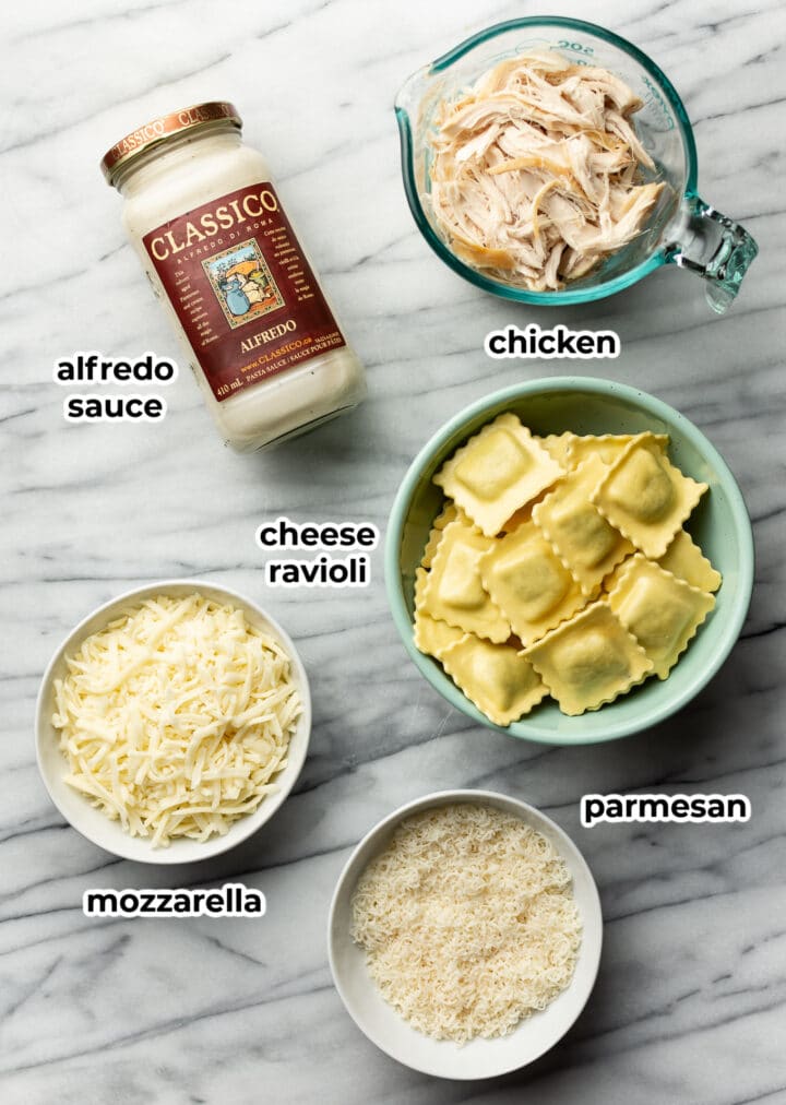 ingredients for chicken alfredo ravioli bake in prep bowls