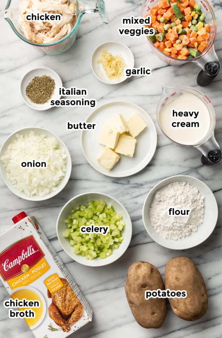 ingredients for chicken pot pie soup in prep bowls on a counter