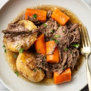 a plate with a portion of instant pot pot roast and a fork