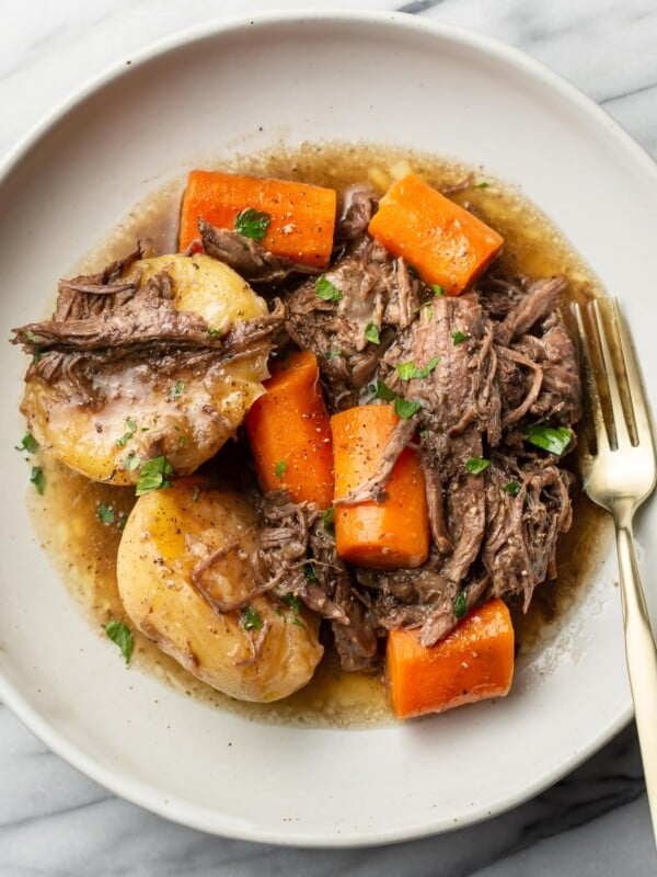 a plate with a portion of instant pot pot roast and a fork