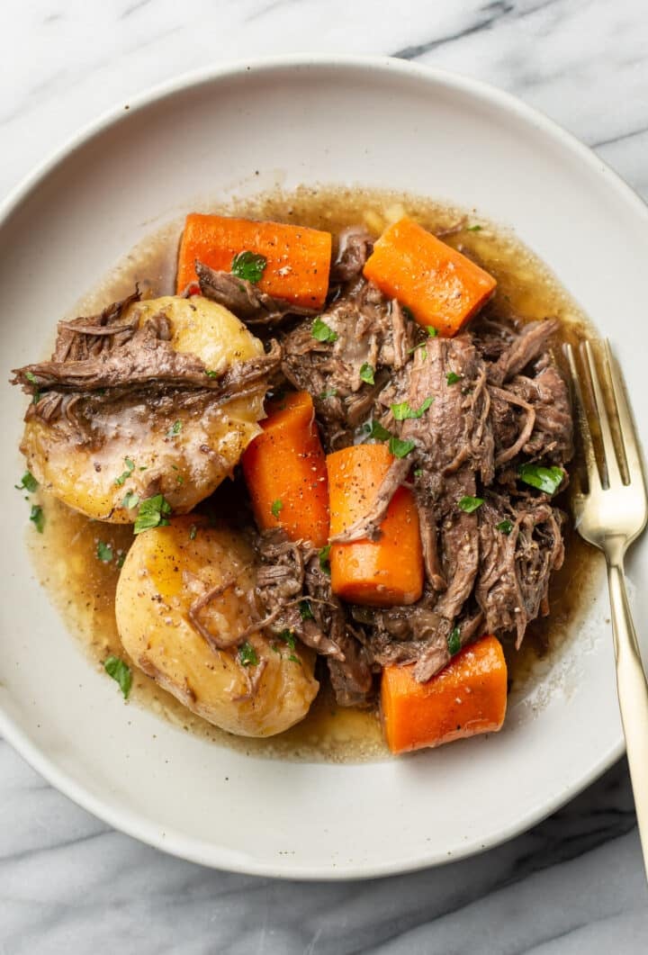 a plate with a portion of instant pot pot roast and a fork