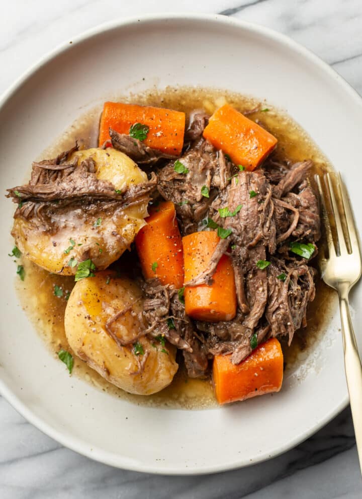 a plate with a portion of instant pot pot roast and a fork