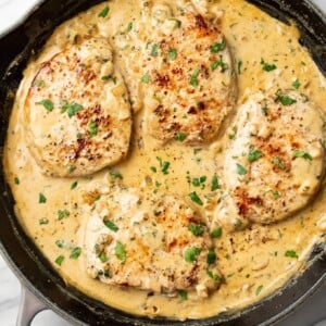 a cast iron skillet with boursin pork chops