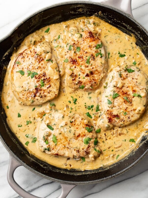 a cast iron skillet with boursin pork chops