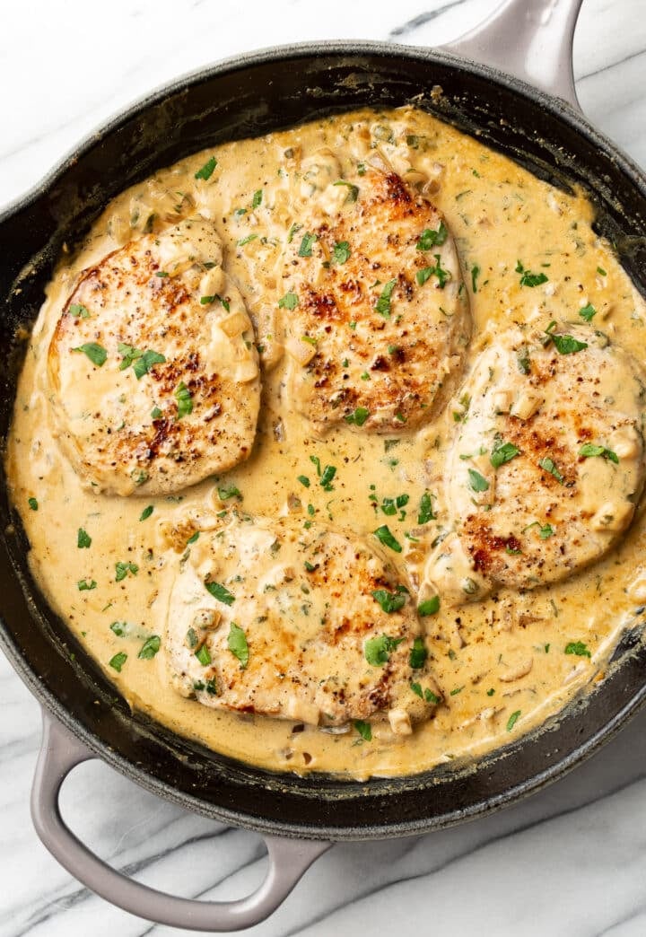 a cast iron skillet with boursin pork chops