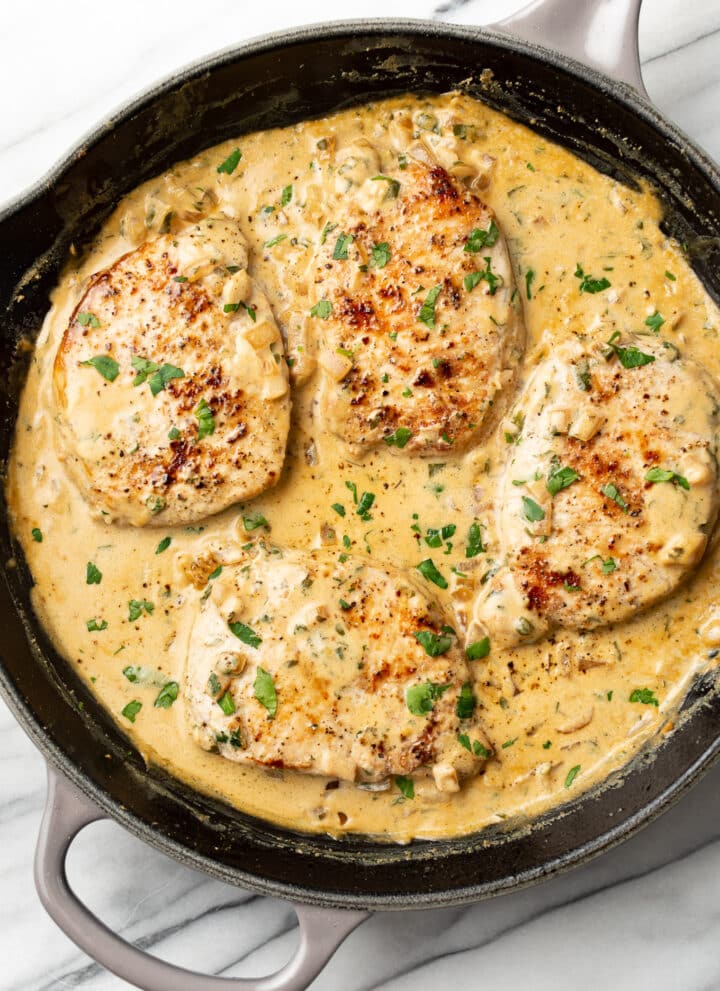a cast iron skillet with boursin pork chops
