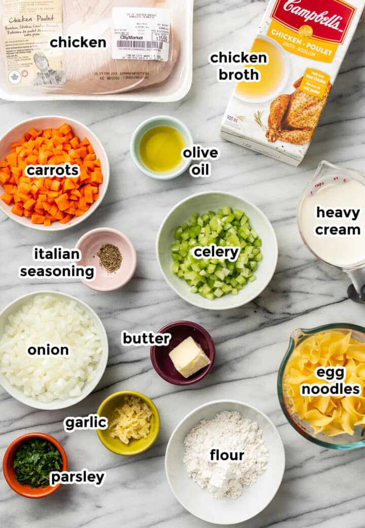 ingredients for creamy chicken noodle soup in prep bowls