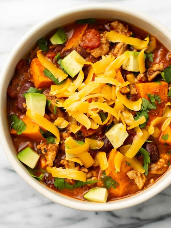 a bowl of sweet potato turkey chili with toppings